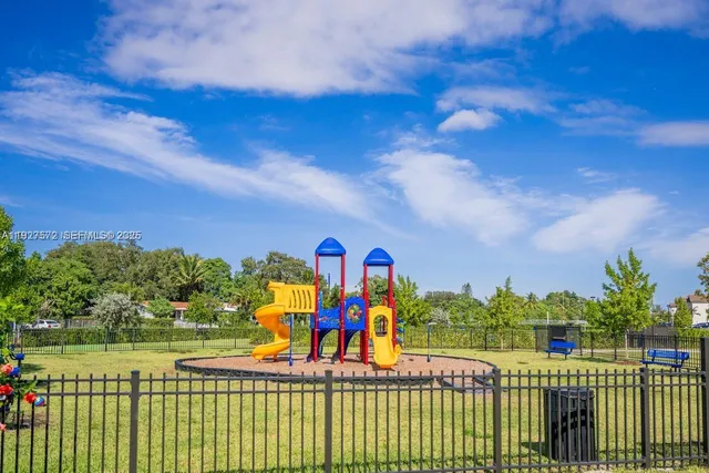 a view of a park with iron fence