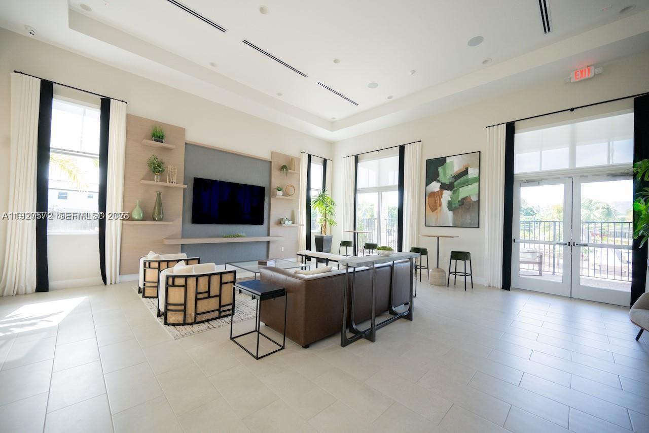 2281 Northwest 131st Circle Miami, FL 33167 - Photo 45 of 48 a living room with furniture flat screen tv and large windows