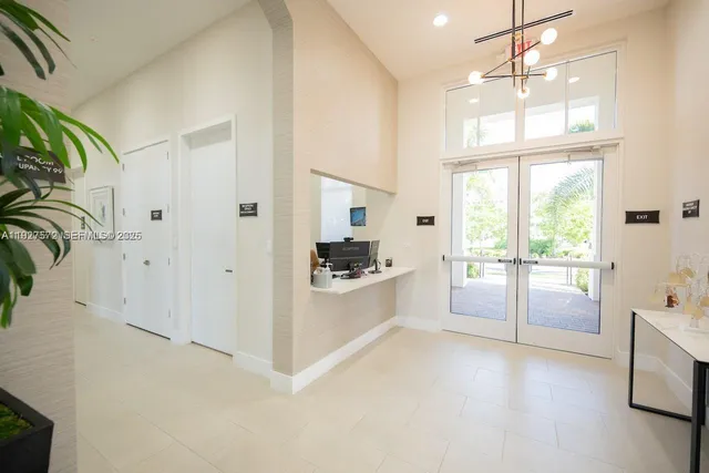 a large white kitchen with cabinets a sink and a window