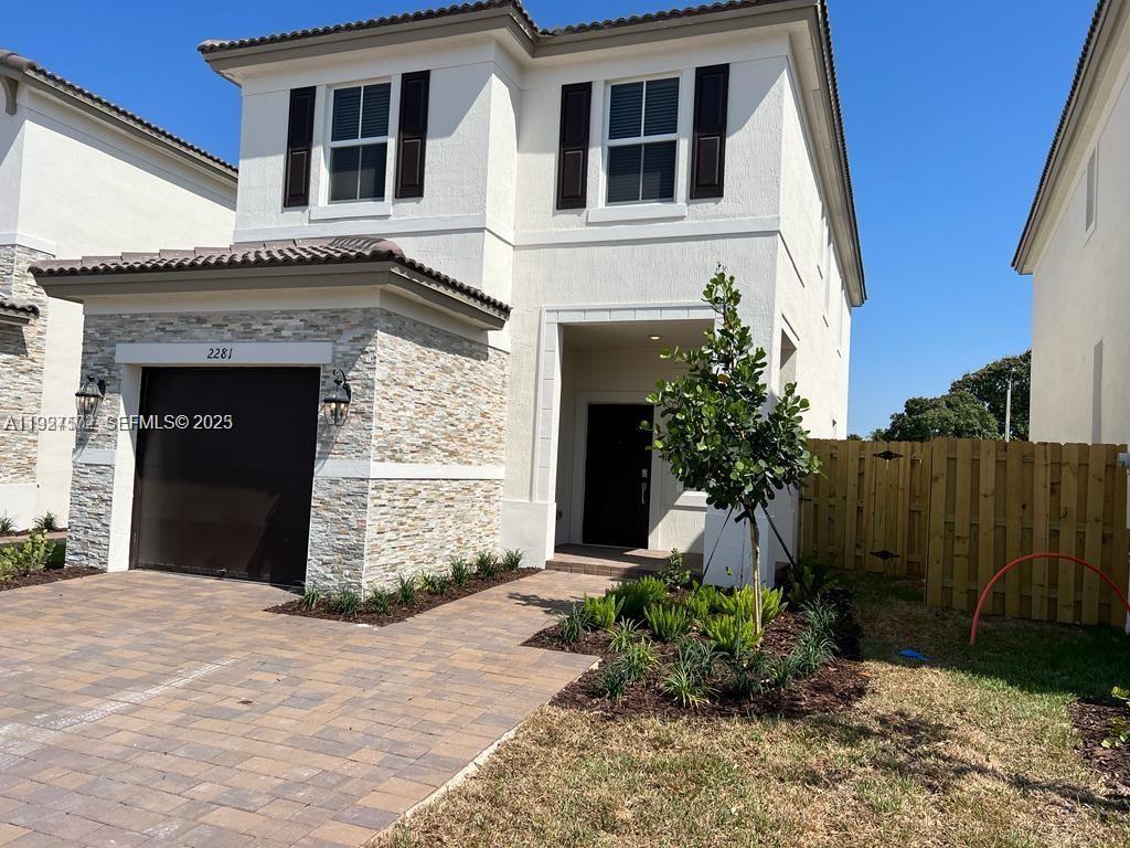 2281 Northwest 131st Circle Miami, FL 33167 - Photo 6 of 48 a front view of a house with garden
