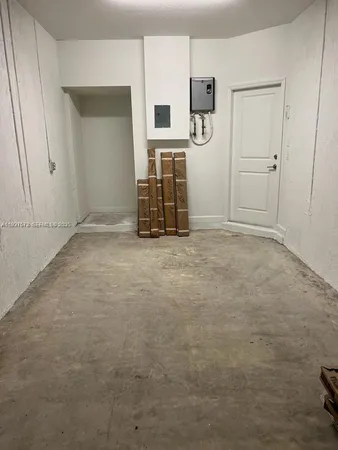 an empty room with closet and mirror