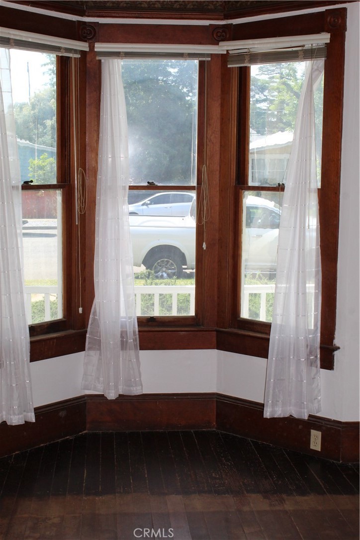 1414 Marin Street Corning, CA 96021 - Photo 12 of 71 a view of empty room with wooden floor and front door
