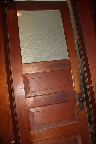 a view of a balcony with wooden floor and fence