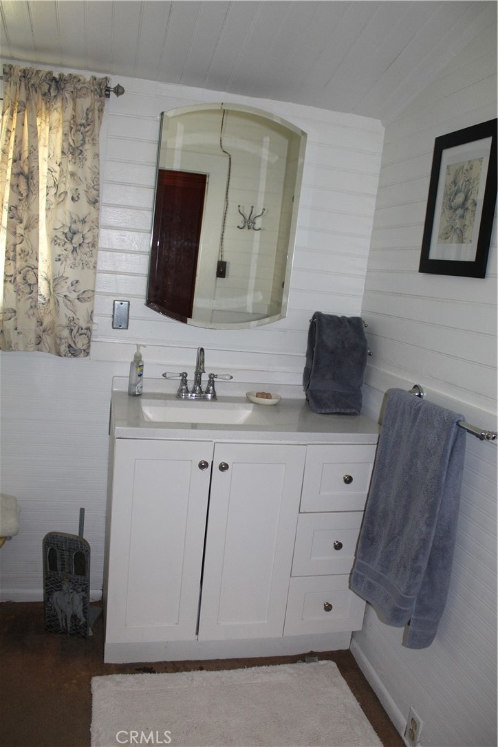 1414 Marin Street Corning, CA 96021 - Photo 36 of 71 a bathroom with a double vanity sink and mirror