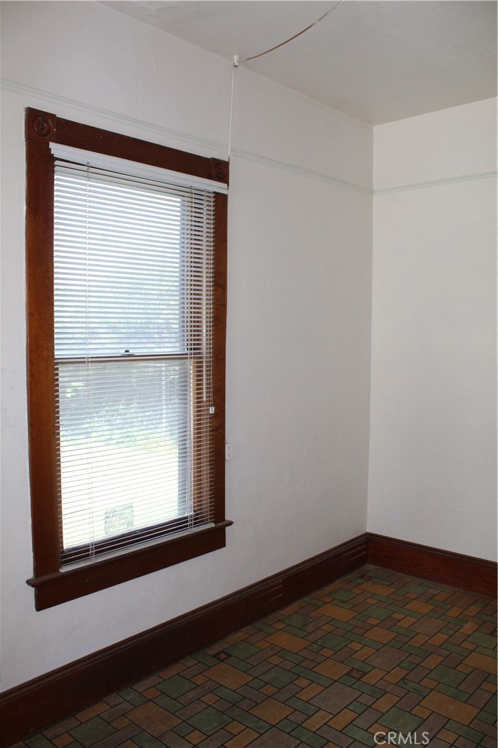 1414 Marin Street Corning, CA 96021 - Photo 42 of 71 a view of an empty room with wooden floor and a window
