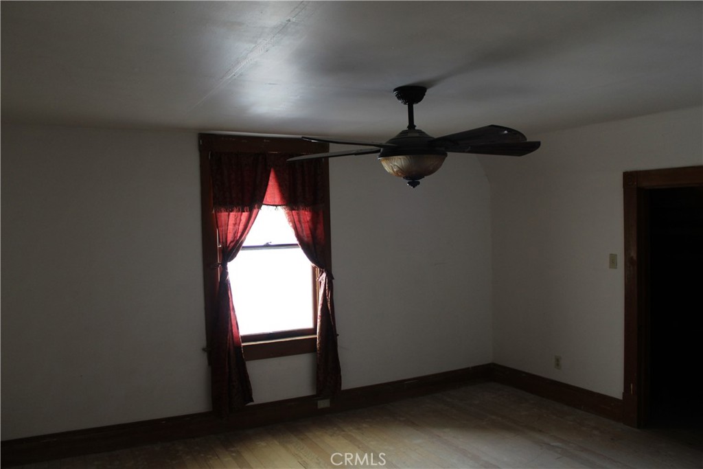 1414 Marin Street Corning, CA 96021 - Photo 49 of 71 an empty room with a window and a ceiling fan