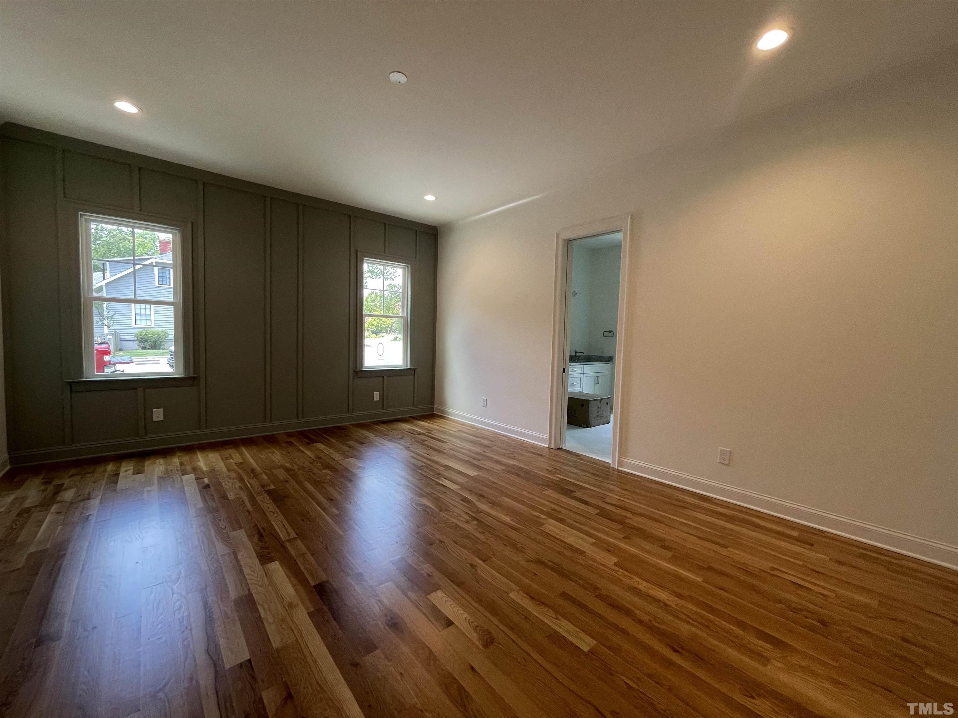 400 Pershing Road Raleigh, NC 27608 - Photo 17 of 33 an empty room with wooden floor and windows