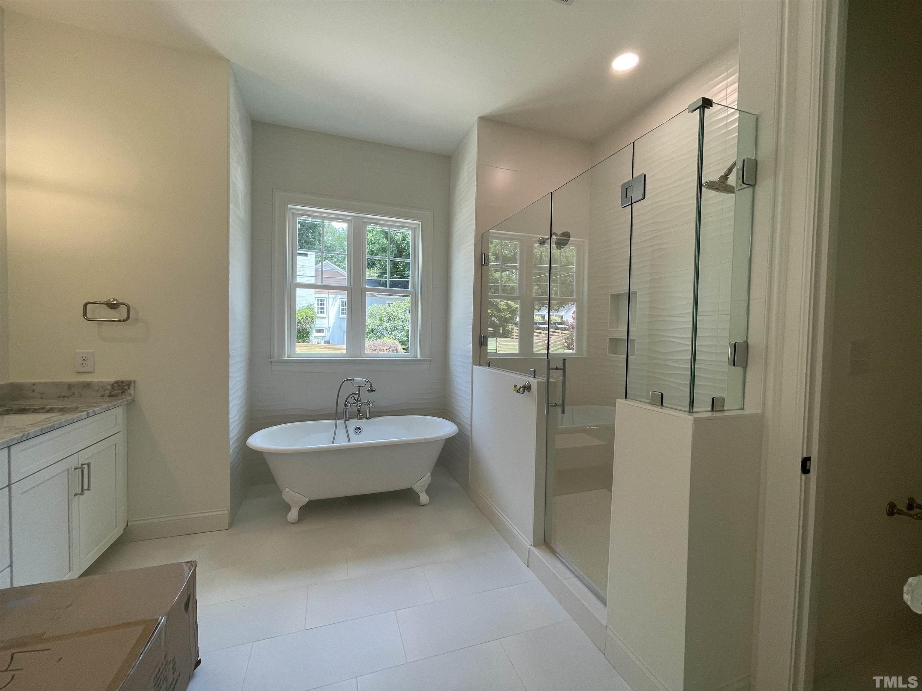 400 Pershing Road Raleigh, NC 27608 - Photo 20 of 33 a spacious bathroom with a granite countertop sink a toilet a mirror and shower