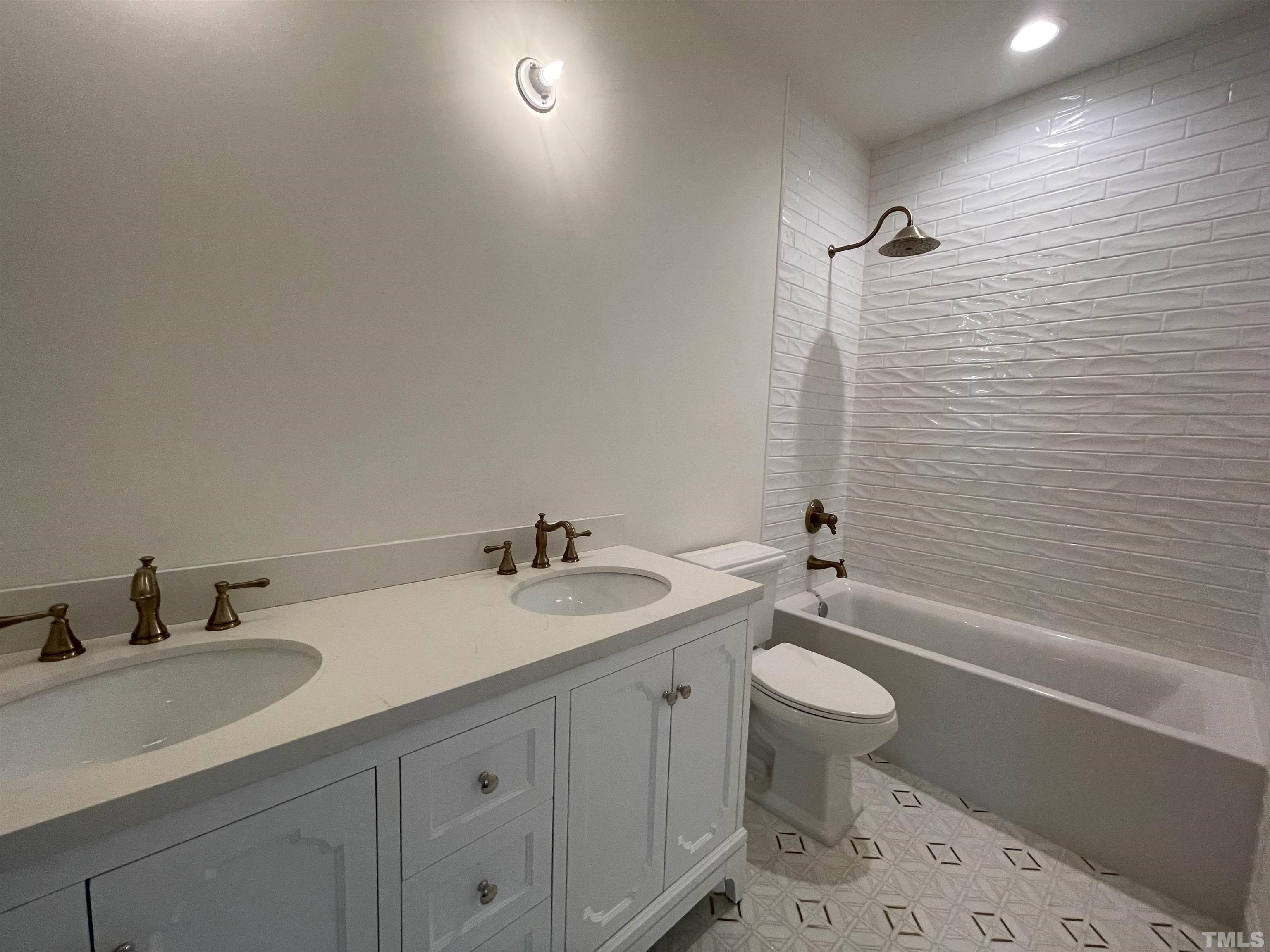 400 Pershing Road Raleigh, NC 27608 - Photo 23 of 33 a bathroom with a granite countertop sink a toilet and a bathtub