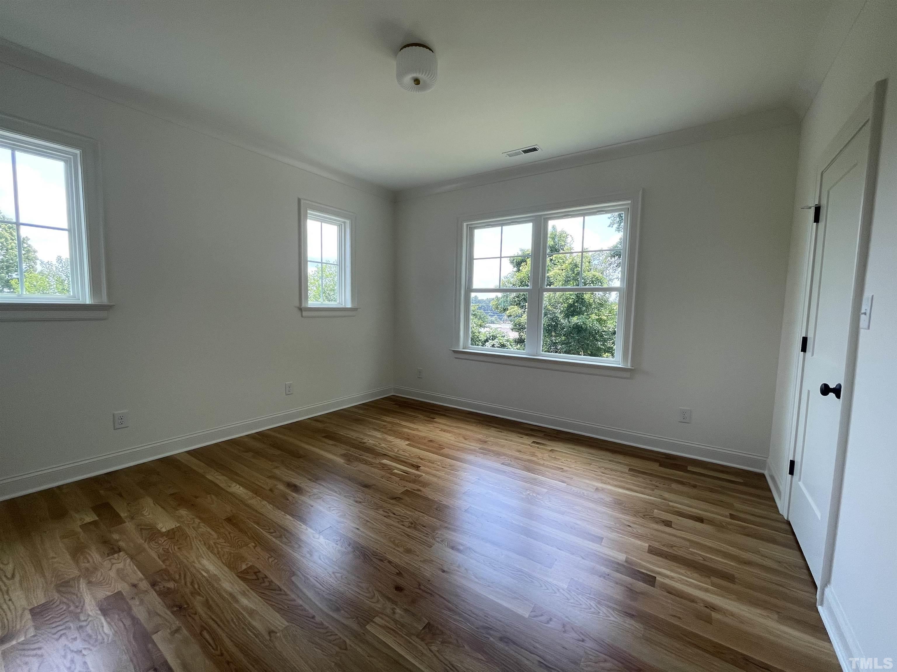 400 Pershing Road Raleigh, NC 27608 - Photo 24 of 33 a view of an empty room with wooden floor and a window