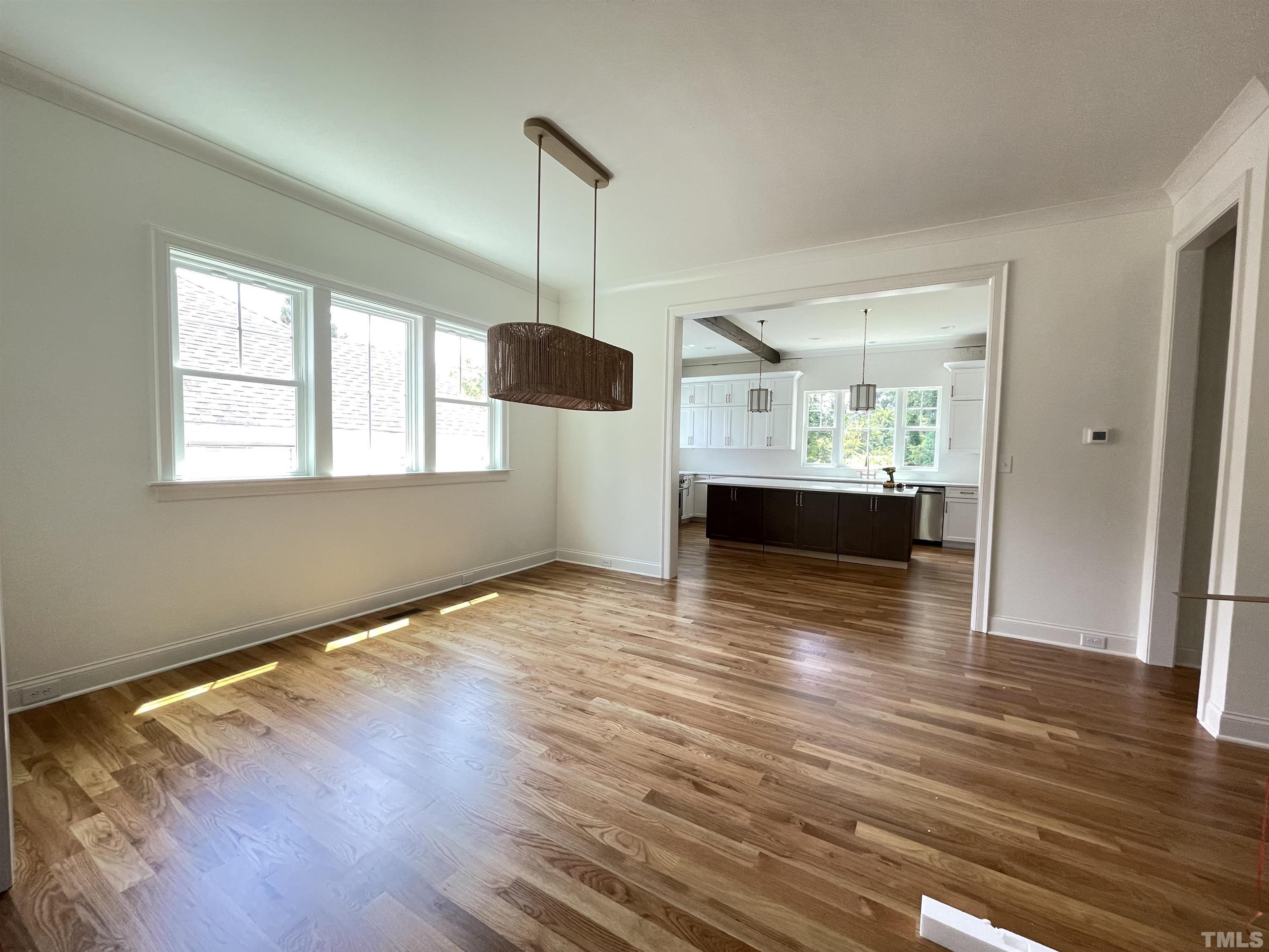 400 Pershing Road Raleigh, NC 27608 - Photo 10 of 33 a view of empty room with wooden floor and window