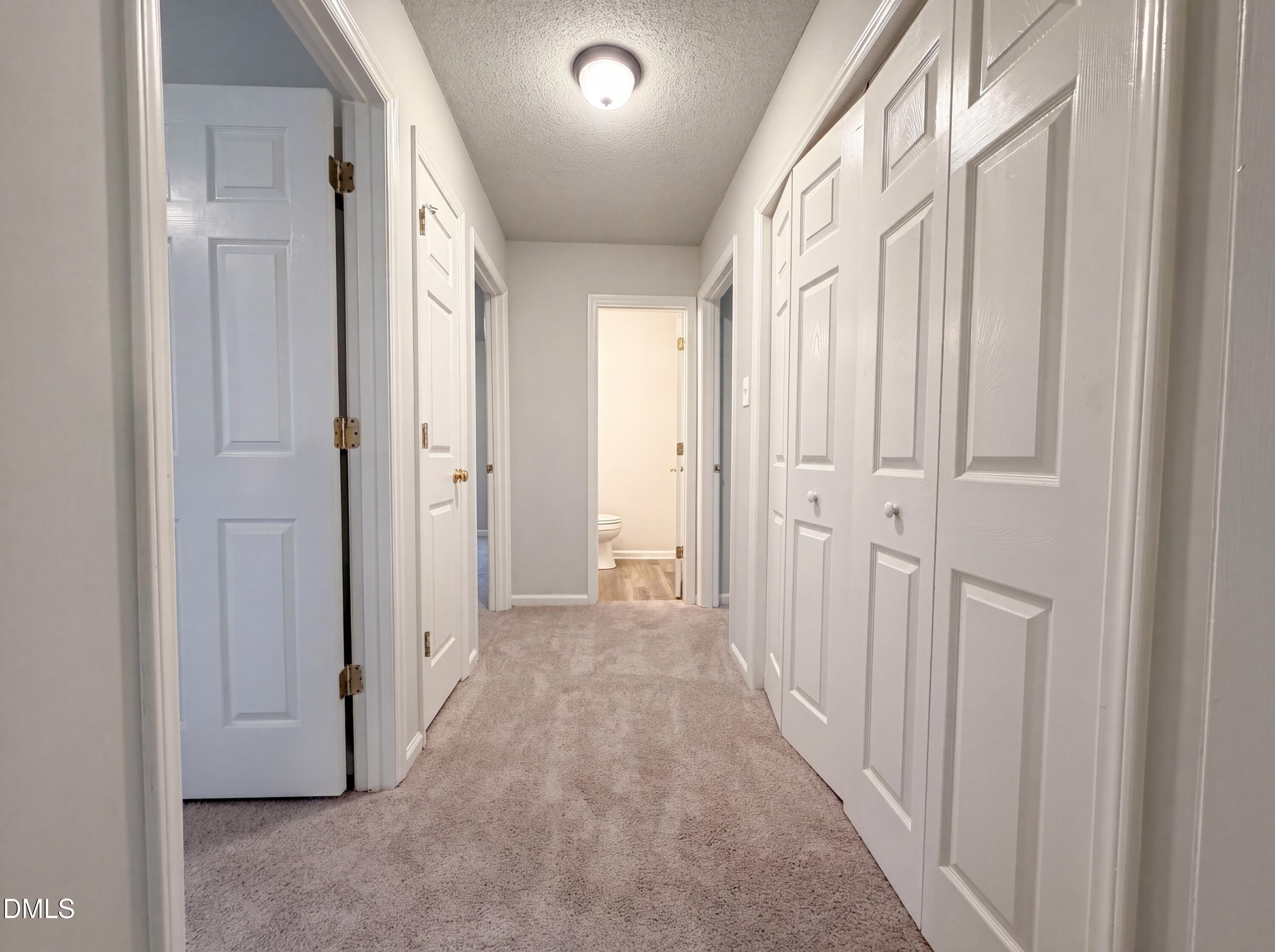 4894 Elevation Road, Unit C Benson, NC 27504 - Photo 14 of 24 a view of a hallway with white doors