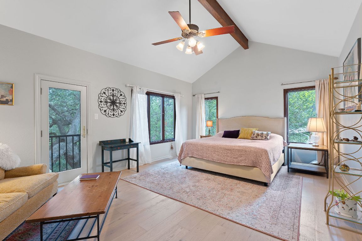 6302 Gato Path Austin, TX 78731 - Photo 15 of 37 Bedroom featuring wood finished floors, beam ceiling, high vaulted ceiling, access to outside, and ceiling fan