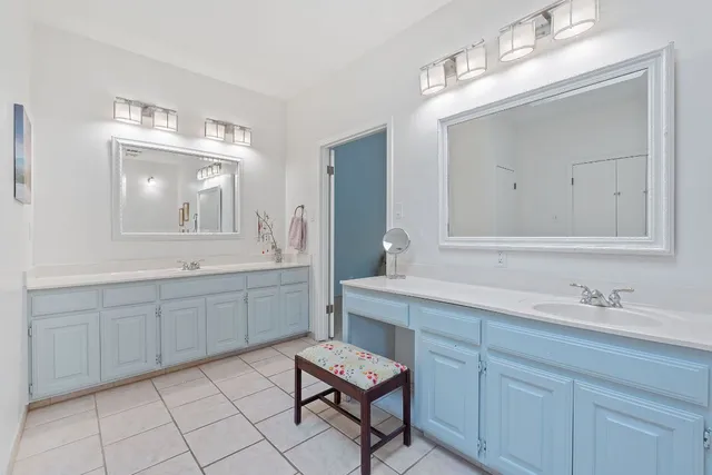 a bathroom with a sink vanity and mirror