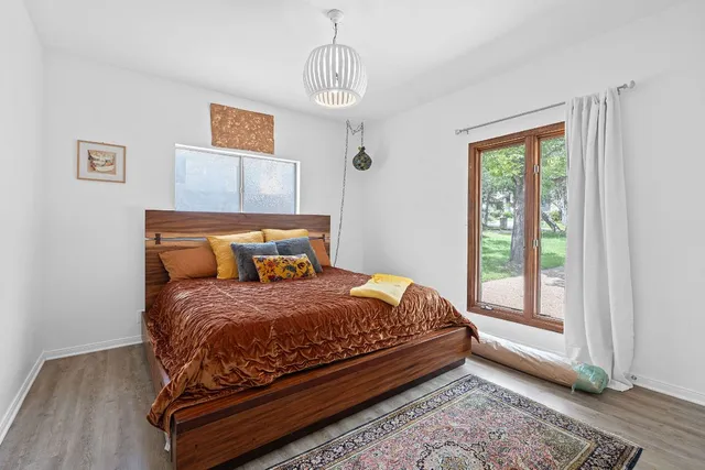 a bedroom with a bed and window