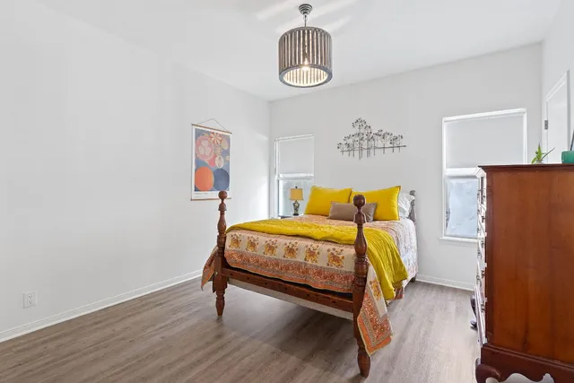 a bedroom with a bed and wooden floor