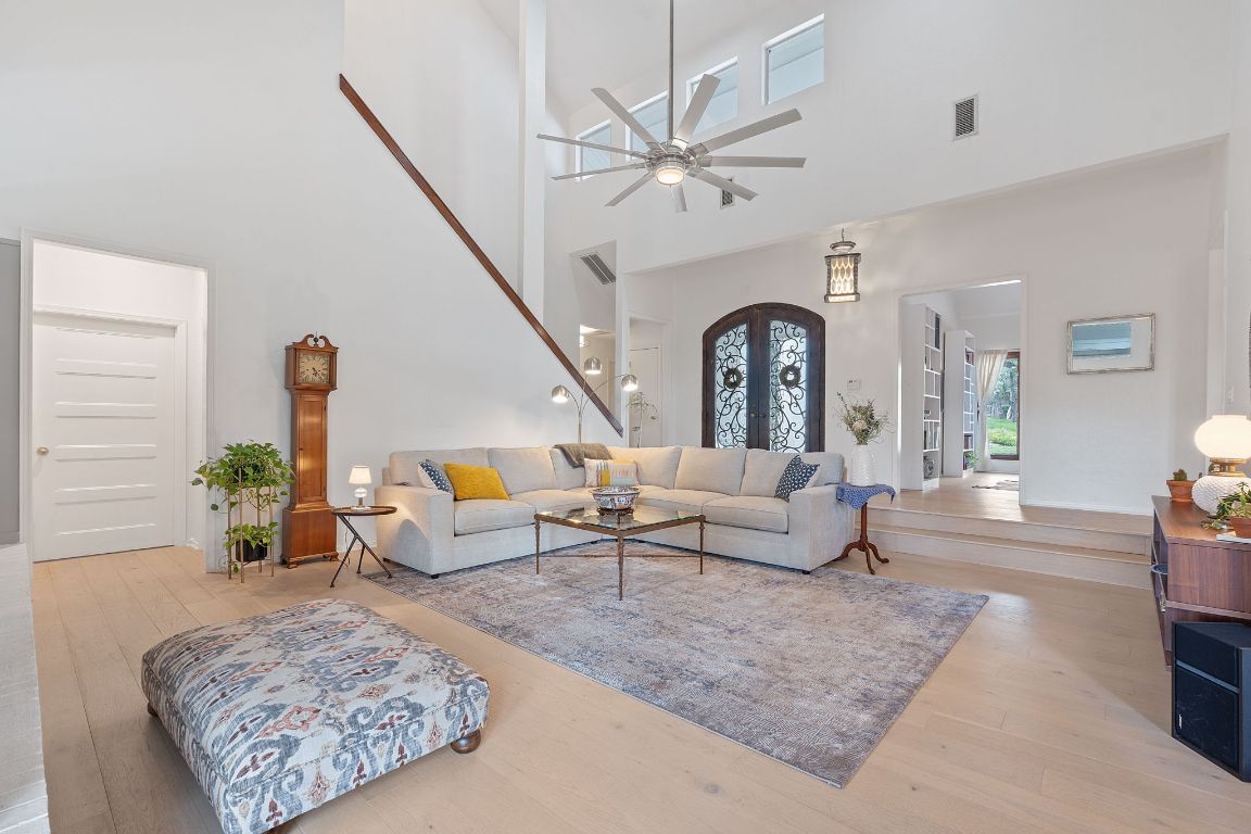 6302 Gato Path Austin, TX 78731 - Photo 3 of 37 Living room with a high ceiling, wood finished floors, and a ceiling fan