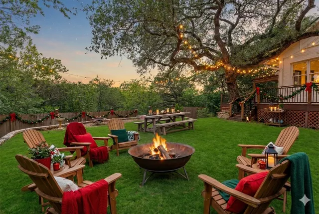 a view of a backyard with large trees