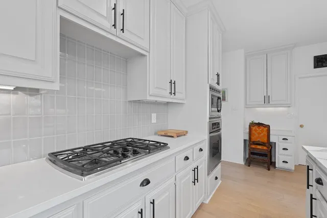 a kitchen with cabinets and appliances
