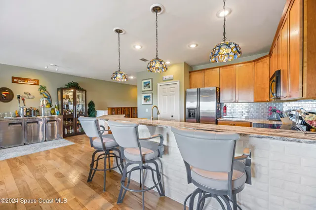 a dining table chairs and chandelier
