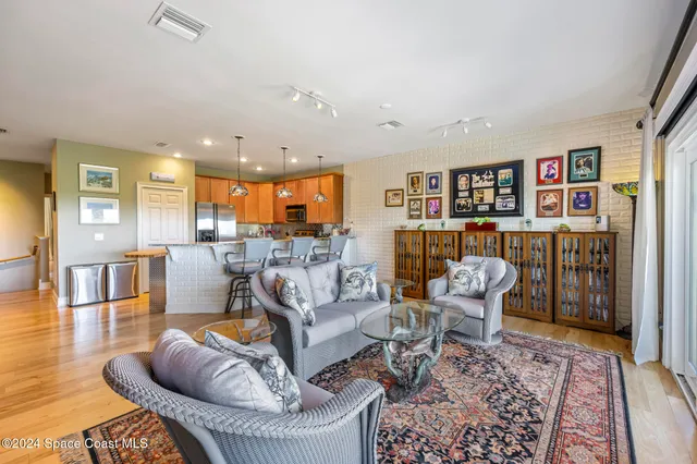a living room with furniture and a book shelf