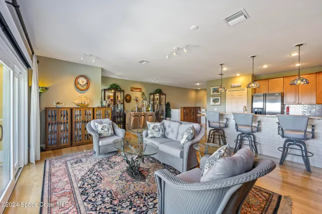 a living room with furniture and view of kitchen