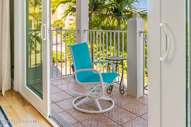 a view of a chairs and table in a balcony
