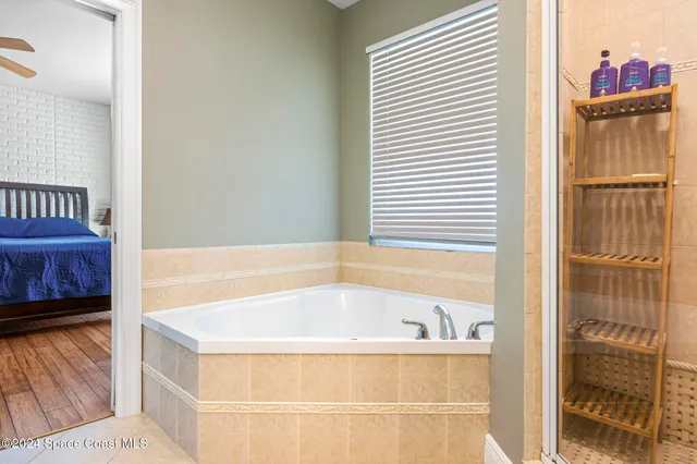 a bathroom with a granite countertop double vanity sink and a mirror