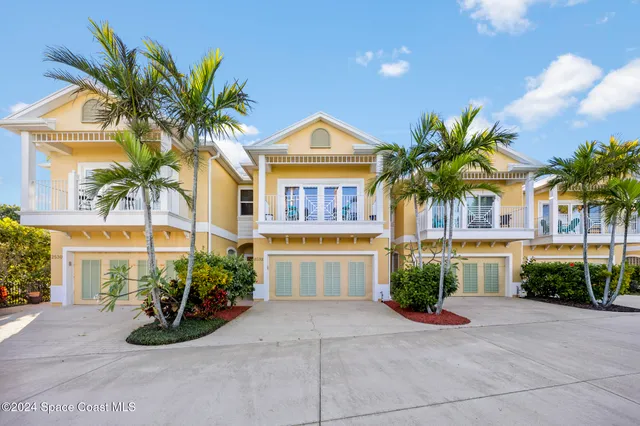 a front view of a house with a yard and a garage