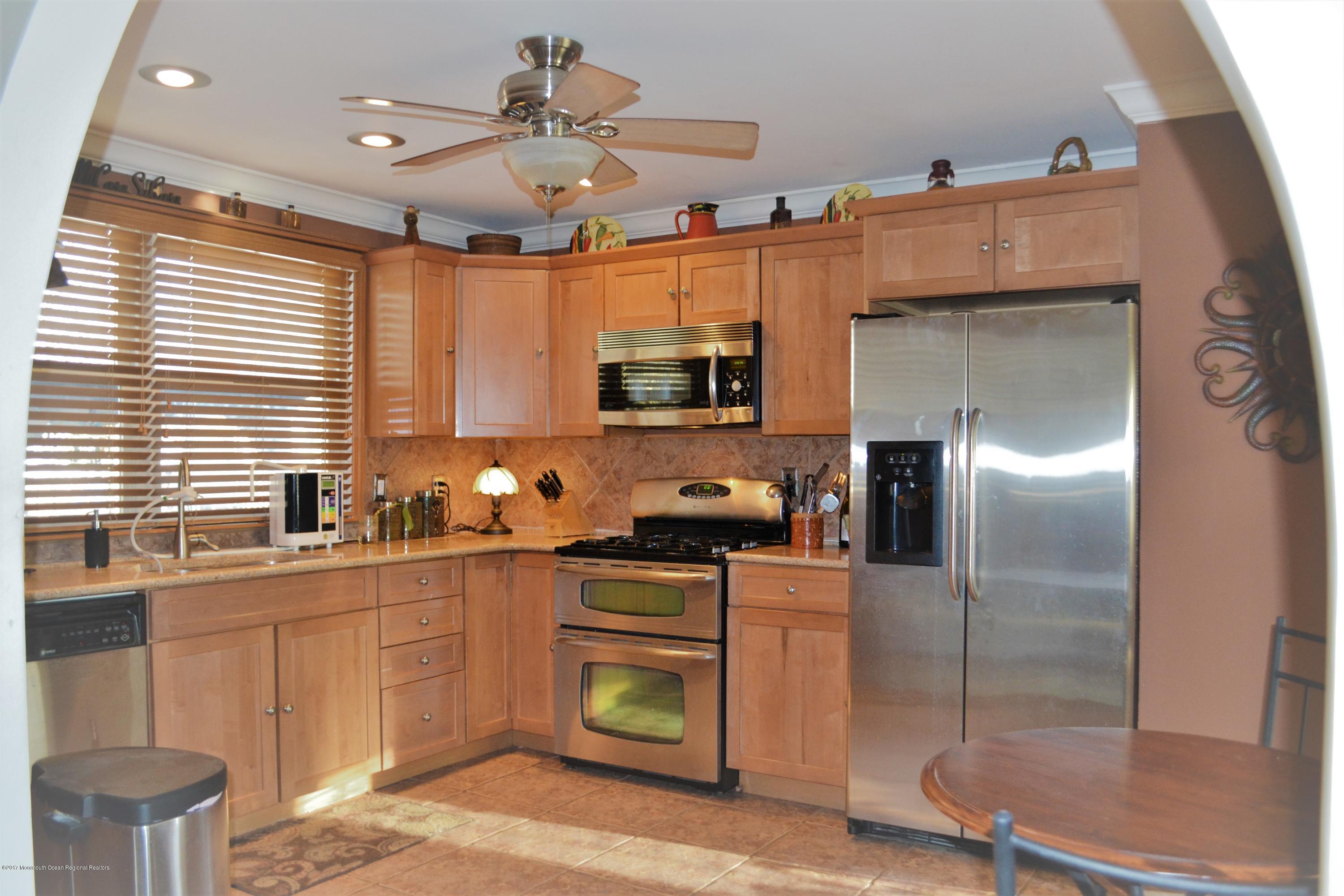 615 Midstreams Road Brick, NJ 08724 - Photo 5 of 10 a kitchen with stainless steel appliances granite countertop a sink a stove and a refrigerator
