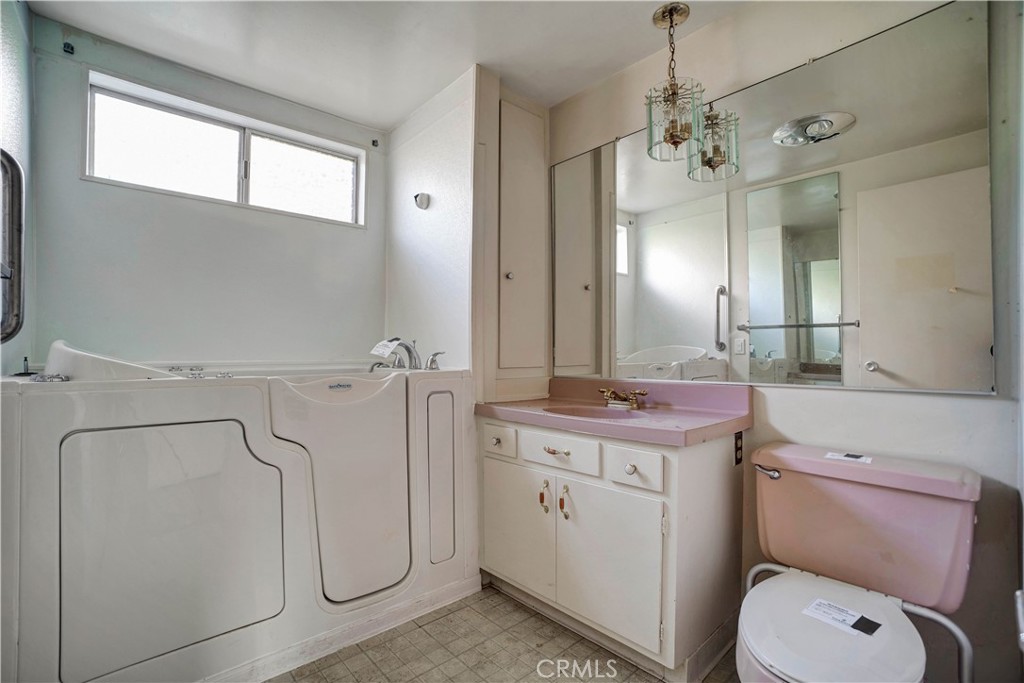 1006 North Orange Avenue Fallbrook, CA 92028 - Photo 17 of 21 a bathroom with a granite countertop toilet sink and mirror