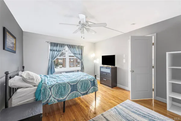 a bedroom with a bed and a television