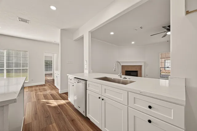 a spacious bathroom with a granite countertop sink mirror and bathtub