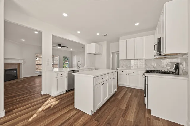a kitchen with wooden floors and white appliances