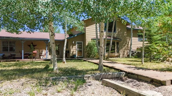 a view of a house with backyard porch and sitting area