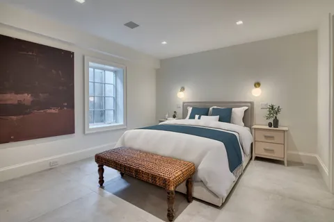 a bedroom with a bed and window