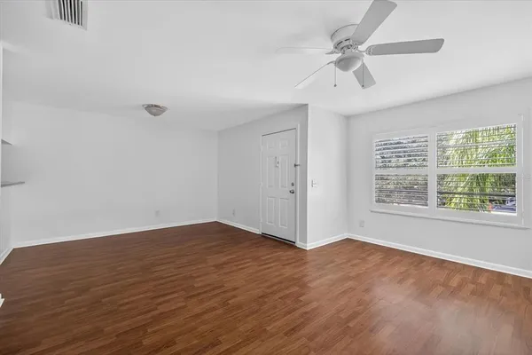 wooden floor in an empty room with a window