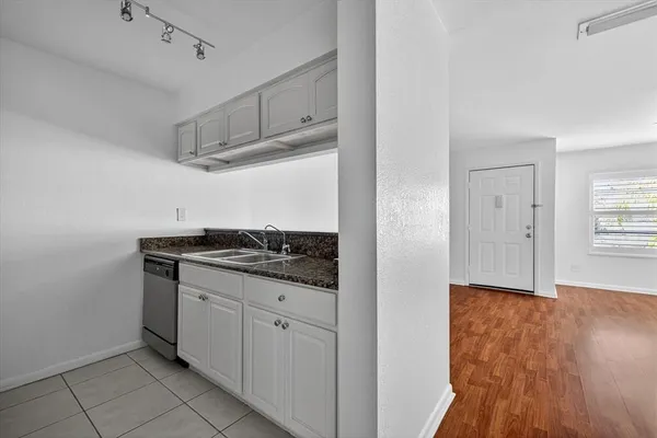 a kitchen with granite countertop a sink and a stove top oven