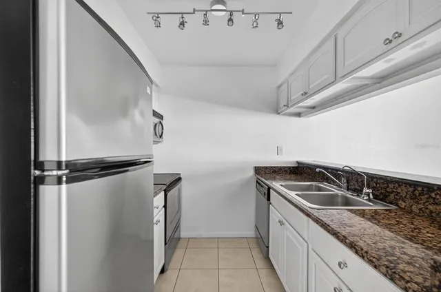 a kitchen with a refrigerator and a sink
