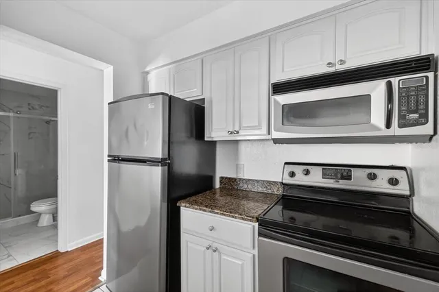 a kitchen with cabinets and steel stainless steel appliances
