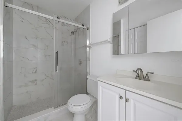 a bathroom with a sink toilet and shower