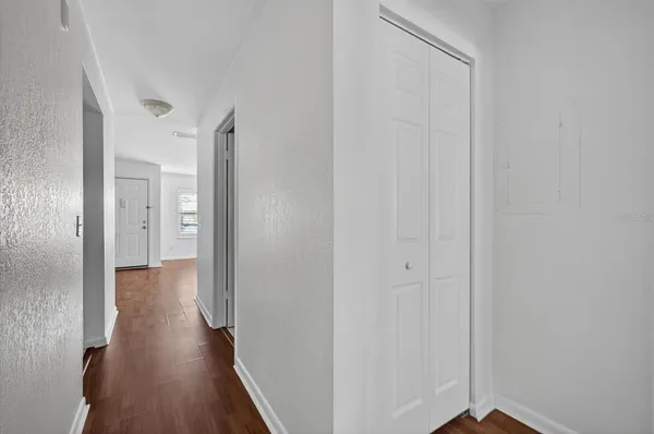a view of a hallway with wooden floor