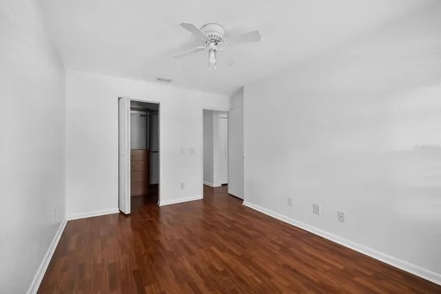a view of an empty room with wooden floor