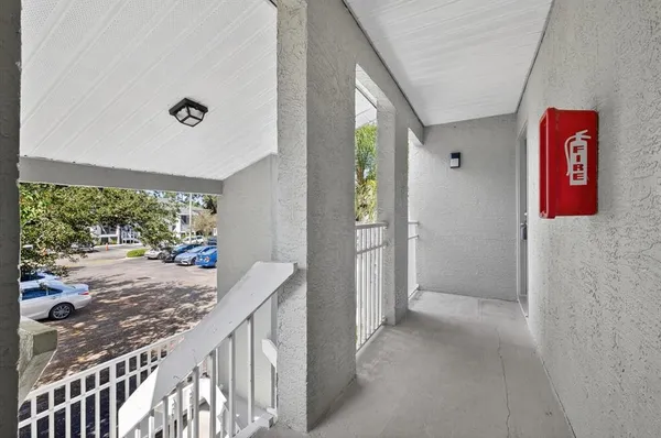 a view of a hallway to a livingroom with furniture