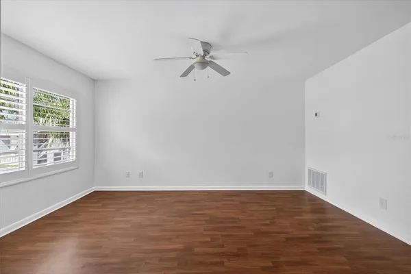 wooden floor in an empty room with a window