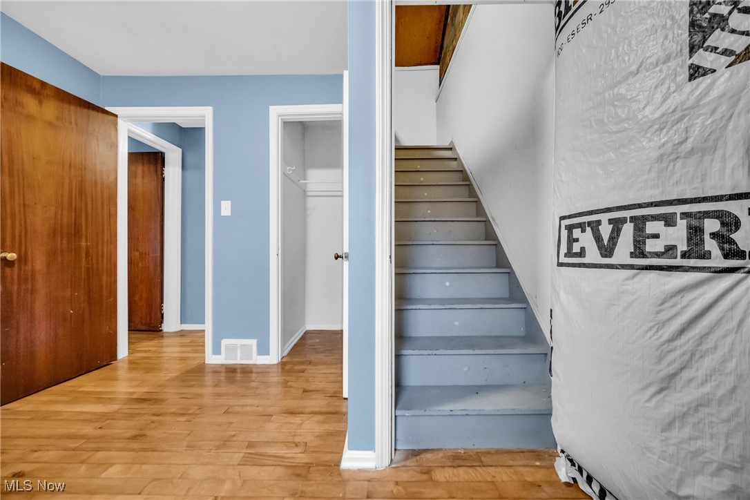 1605 Laclede Road Cleveland, OH 44121 - Photo 16 of 40 Staircase featuring wood finished floors and visible vents