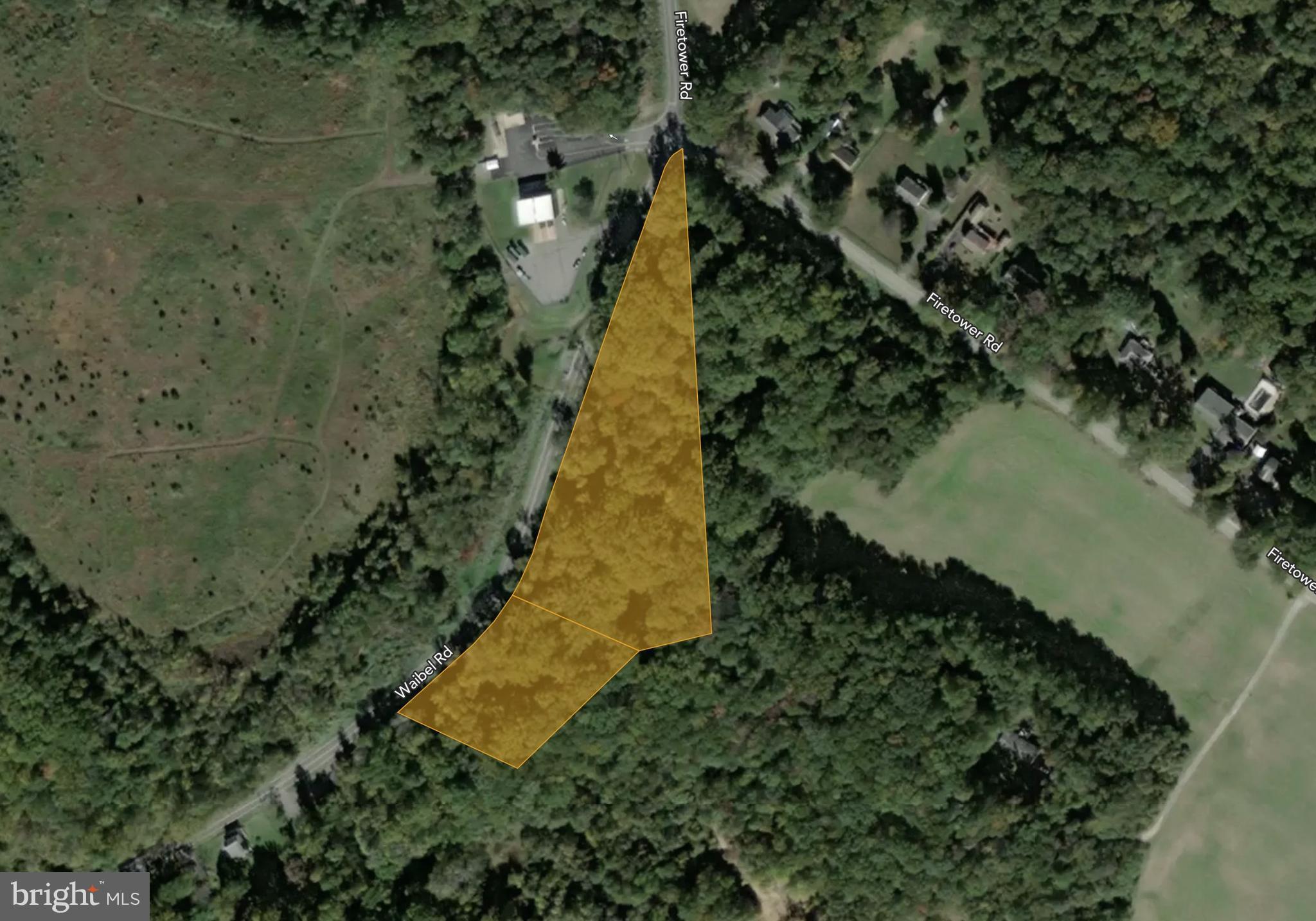 a aerial view of a house with a yard and lake view