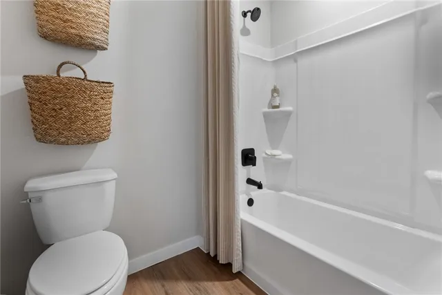 a bathroom with a toilet a sink and bathtub