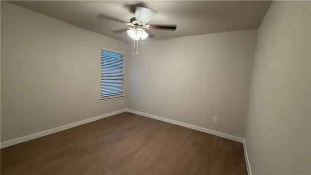 a kitchen with stainless steel appliances granite countertop a sink and a stove top oven with wooden floor