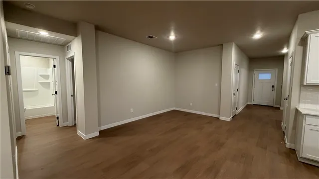 a kitchen with stainless steel appliances a sink a stove top oven a white counter space and cabinets